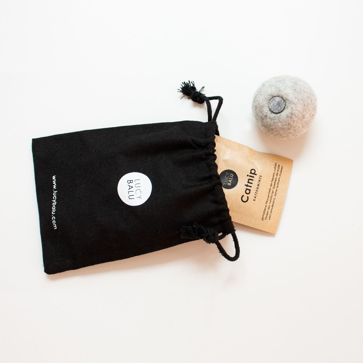 Balle en feutre MINT BALL avec sachet d'herbe à chat et pochette en tissu LucyBalu noire en guise d'emballage